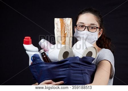Young Woman In Protective Mask With A Bag Full Of Groceries From The Supermarket
