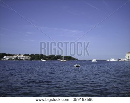 View From The Shore To The Island Where There Is A Beautiful Large House. On The Blue Water Of The B