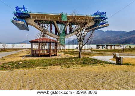 Sejong, South Korea; April 1, 2020: Picnic Shelter In Front Of Section Of New Bridge Under Construct