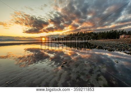 Beautiful Sunset Along A Rocky Beach With Big Waves