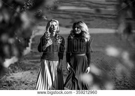 Colorful Fall. Female Beauty. Real Femininity. Autumn Women Outdoor. Girl Friends Walk In Park. Sunn