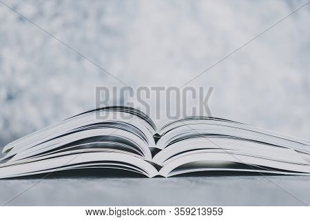 Education And Self-improvement, Pile Of Open Books Shot From Eye Level With Shallow Depth Of Field