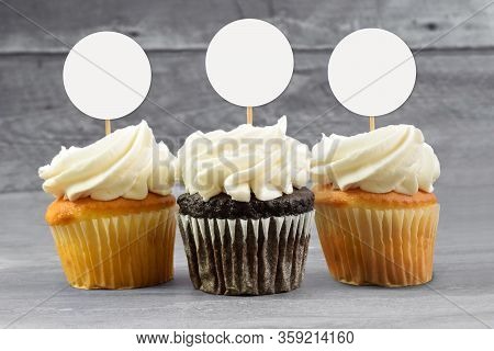 Cupcake Topper Mockup Featuring Chocolate And Yellow Cupcakes Sitting Temptingly On A Gray Wooden Ba