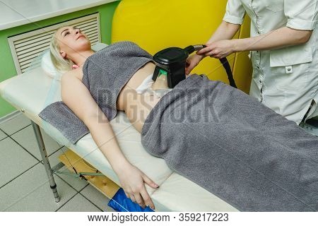 Woman Getting Cryolipolysis Fat Treatment Procedure In Beauty Salon