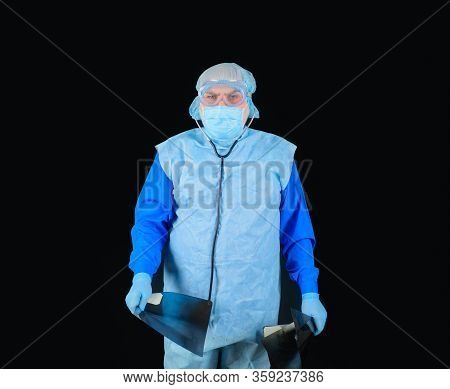 Medical Check. Male Doctor With X-ray. Male Doctor In Protective Suit Looking At X-ray. Radiologist 