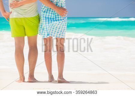 Legs Of Young Kissing Couple On Tropical Turquoise Caribbean Beach. Cayo Largo, Cuba