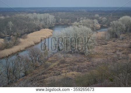 Beautiful Autumn Landscape In The Evening. Dry Grass On A Hill And A View Of The Valley And River Be