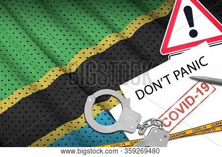 Tanzania Flag And Police Handcuffs With Inscription Dont Panic On White Paper. Coronavirus Or 2019-n