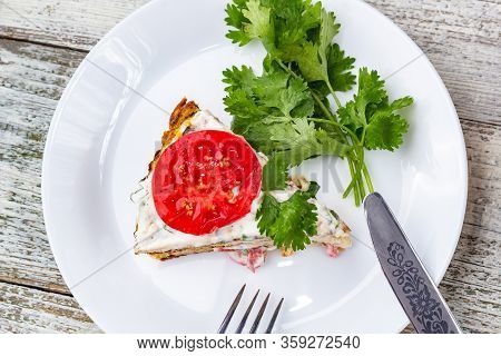 Pice Of Zucchini Cake With Tomatoes And Fresh Parsley On White Wooden Background.