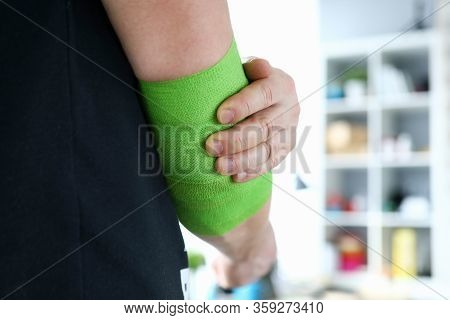 Close-up Of Male Person Wearing Green Swathe Wrap. Sportsman With Damaged Hand In Elastic Bandage. M