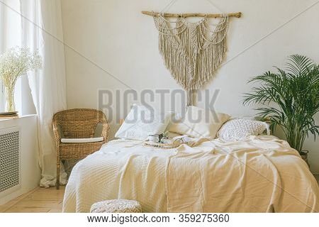 Modern Romantic Scandi Boho Style Bedroom Interior With Decorative Pillows, Green Plant And Diy Macr