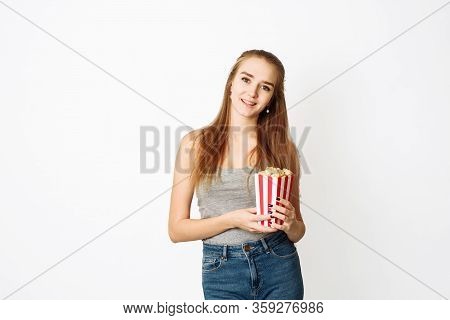 Beautiful Blonde Girl Eat Popcorn And Watch Comedia Movie Isolated On White Background. Copy Space, 