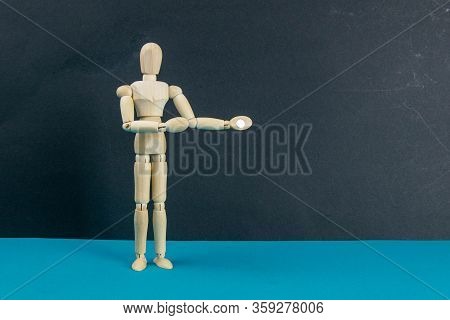 Wooden Mannequin On Black Table And Blue Background. Trun Right Concept. Close-up