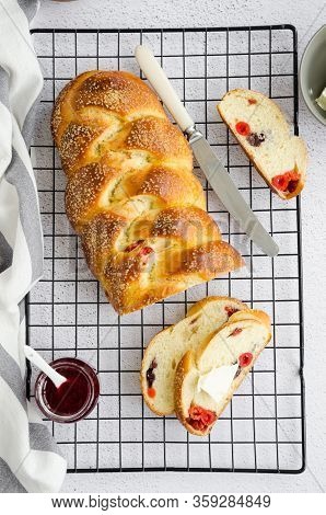Traditional Sweet Easter Bread With Raisins, Dried Cherries With Jam And Butter On A Light Backgroun