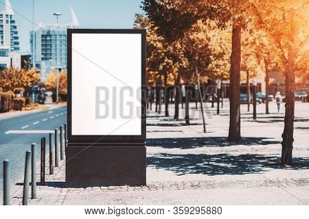 Mockup Of An Empty Advert Billboard In Urban Settings Near A City Road; A Blank Vertical Street Bann