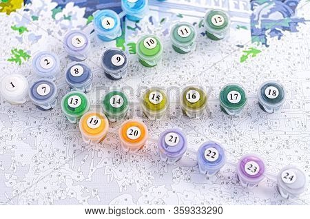 A Set Of Containers With Paints For Home Painting By Numbers. Hobby Painting Canvas With Acrylic Pai