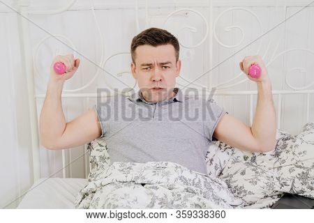 Frick Male In Bed With Little Pink Dumbbells. Bored In Quarantine. Stay Home.