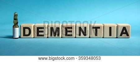 Dementia - Word On Cubes. Drug In Ambula To Reduce Disease Symptoms On A Blue Background