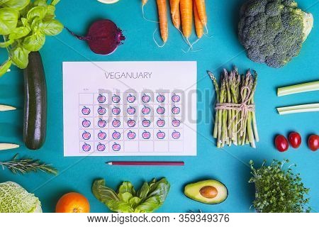 Top View Filled Veginuary Daily Calendar Surrounded With Fresh Vegatevbles And Fruit Ingredients On 