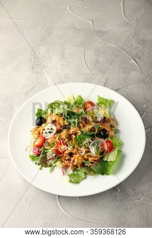 Salad With Chiken And Green In White Plate On Light Background