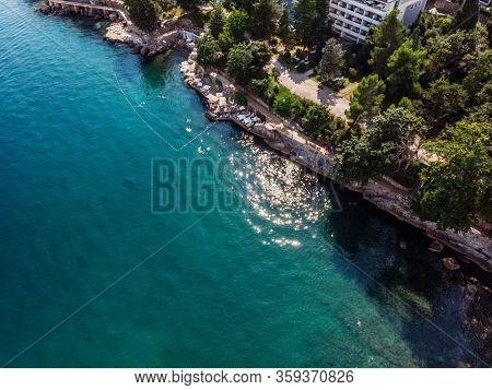 Beautiful panoramic view of Lovran village and its sea shore in Croatia. Top view photo taken on drone.