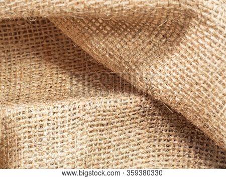 Close Up View On Brown Crumpled Baline. Abstract Background Of Brown Burlap Textile. Texture Of Brow