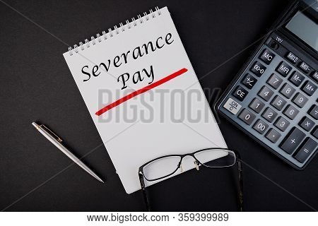 Text, The Inscription, The Phrase Severance Pay Is Written In A Notebook That Lies On A Dark Table W
