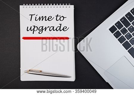 Time To Upgrade Text, Inscription, Phrase Written In A Notebook That Lies On A Dark Table With A Lap