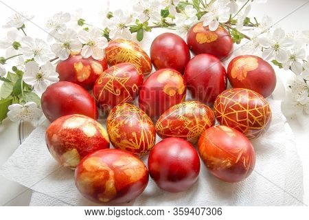 Red Easter Eggs On A Background Of Fresh Flowers.
