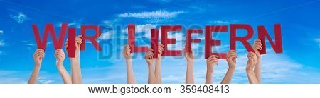 People Hands Holding Word Wir Liefern Means Delivery Service, Blue Sky