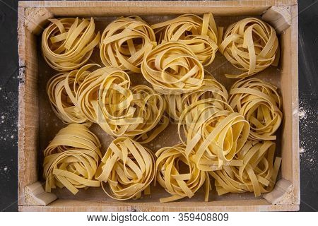 Raw Tagliatelle In A Wooden Box. Top Views