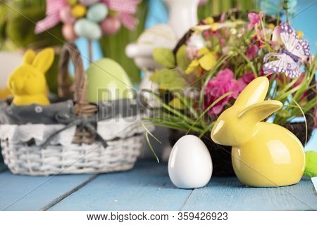Easter Theme. Easter Decorations. Easter Eggs In Basket And Cabbage Leaf. Bouquet Of Spring Flowers.
