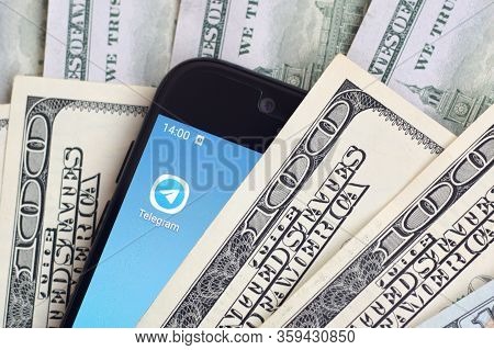 Smartphone Screen With Telegram App And Lot Of Hundred Dollar Bills. Business And Social Networking 