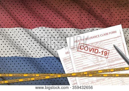 Netherlands Flag And Health Insurance Claim Form With Covid-19 Stamp. Coronavirus Or 2019-ncov Virus