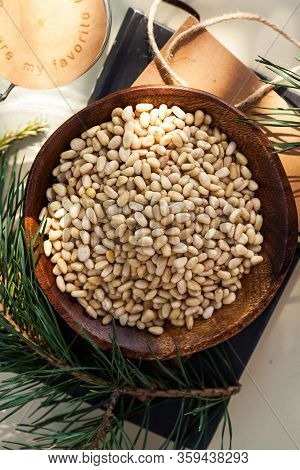 Pine Nuts In A Rustic Plate With A Conifer Branch. Healthy Snack, Nuts.