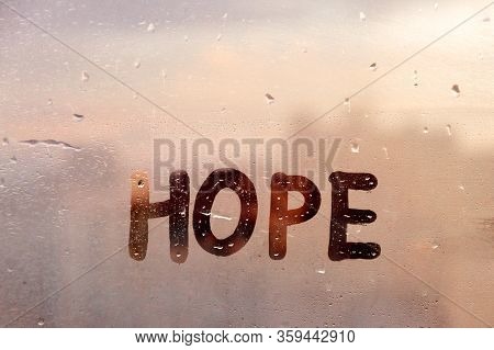 Foggy Glass On Window With Written Finger Word Yellow Color Hope Concept Photo With Copy Space On Bl
