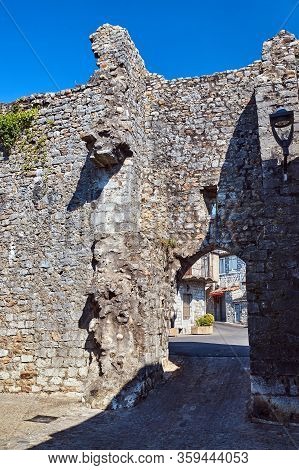 A Medieval Gate In A Stone, Historic Defensive Wall In The City Of Ruoms In France