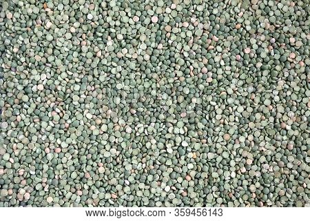 Food Supplies. Crop Of Many Dry Green Green Peases Grains On Flat Surface As Background Top View Clo