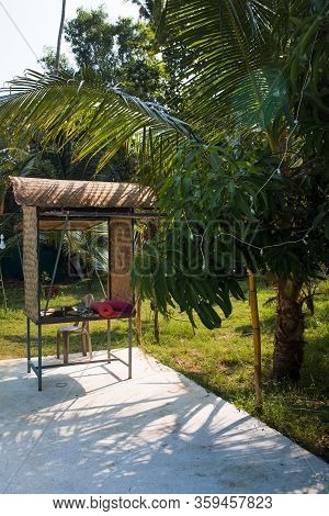 Wicker Gazebo Among Tropical Palms With Yoga Mats. A Place For Outdoor Yoga In India, Kerala.