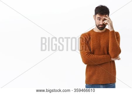 Portrait Of Awkward And Embarrassed Bearded Man Pretend He Not See His Ex, Hiding Face Behind Hand, 