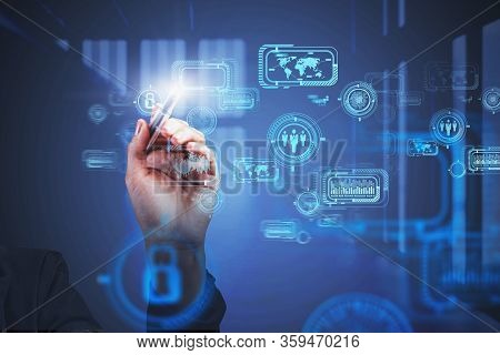 Hand Of Businesswoman Working With Blurry Futurisitc Business Interface In Office. Concept Of Hi Tec
