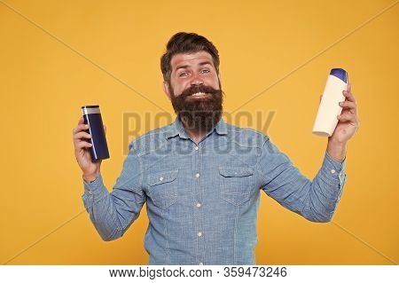 Bath Soap. Bath Cosmetics Review. Man Bearded Hipster Hold Plastic Bottles. Hair Care. Skin Lotion. 