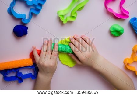Child Hands Playing With Colorful Clay. Homemade Plastiline. Girl Molding Modeling Clay. Homemade Cl