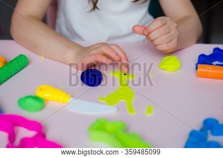 Child Hands Playing With Colorful Clay. Homemade Plastiline. Girl Molding Modeling Clay. Homemade Cl
