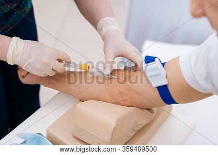 Nurse Drawing Blood Sample From Arm For Blood Test, Close-up. Phlebotomist Technician Drawing Blood 