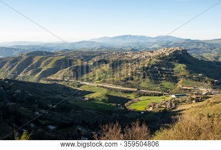 Wide-angle Shot Of Sicilian Landscape With The City Of Calascibetta At Nice Sunset