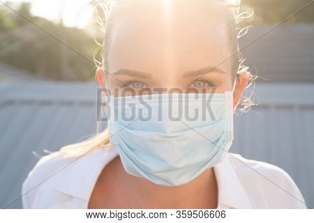 Portrait of woman in protective mask against flu and viruses outdoors. Helathcare, flu epidemic, dust allergy, virus protection, air pollution concept