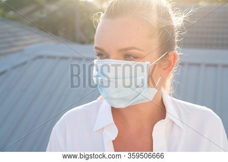 Portrait of woman in protective mask against flu and viruses outdoors. Helathcare, flu epidemic, dust allergy, virus protection, air pollution concept