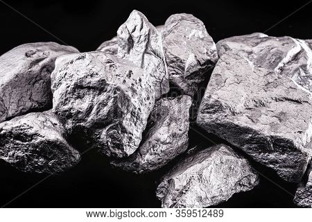 Raw Manganese. Manganese Stone Isolated On Black Background. Mineral Extraction Of Heavy Metals From