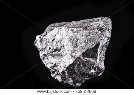 Raw Manganese. Manganese Stone Isolated On Black Background. Mineral Extraction Of Heavy Metals.